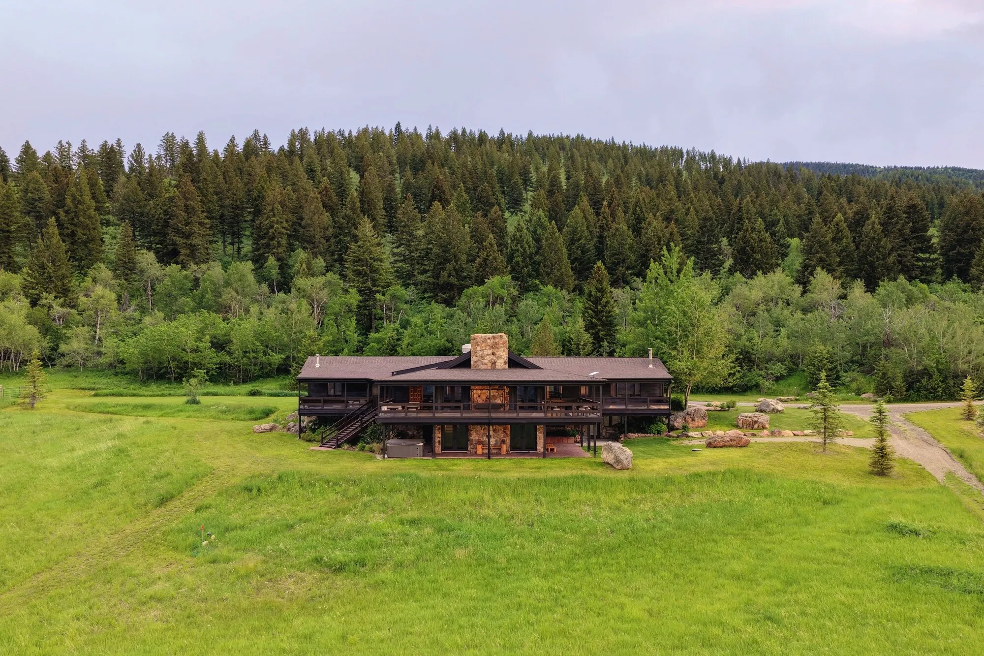The lodge from above: dark timber against the forest edge