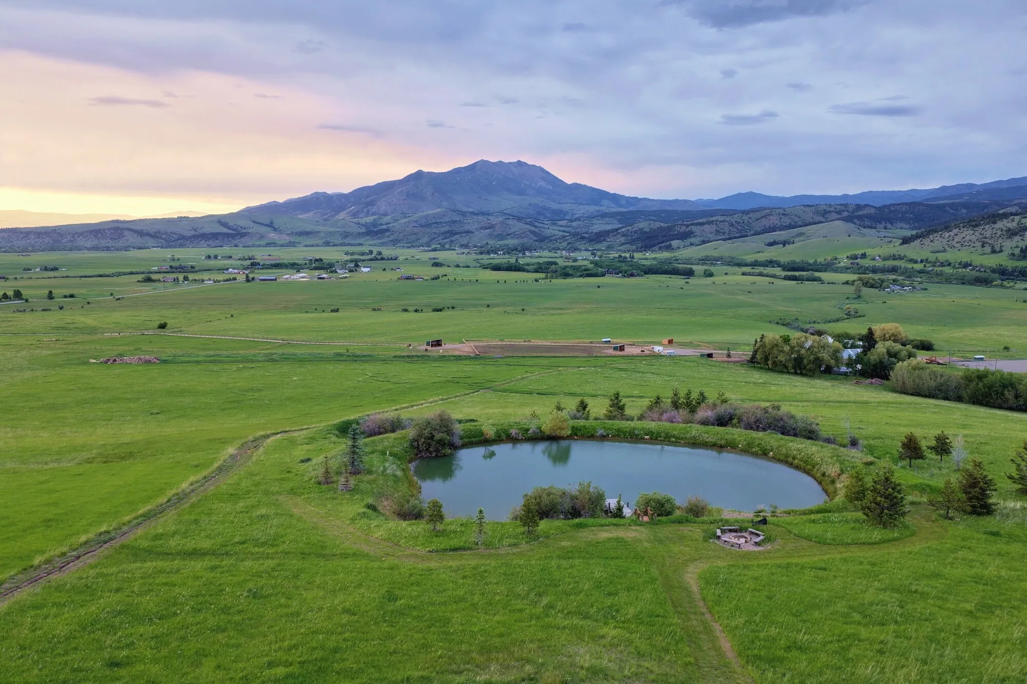 A pond in open meadow at dusk